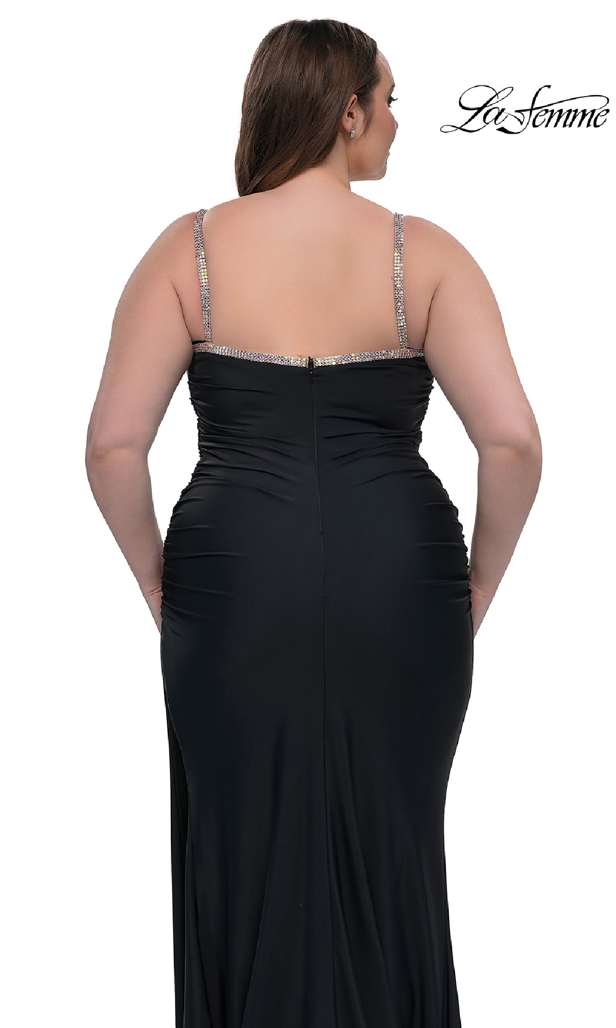 A woman is shown from the back against a white background wearing the Plus-Size Long Prom Dress La Femme 32992—fitted, floor-length, black with thin jeweled straps.